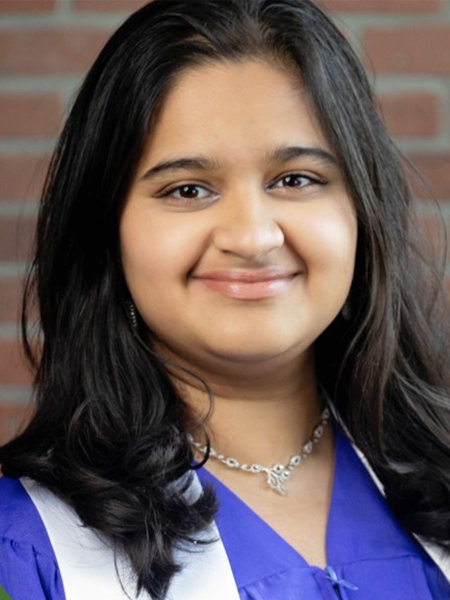 Sampurna Chakravorty wears a blue graduation gown with a white stole