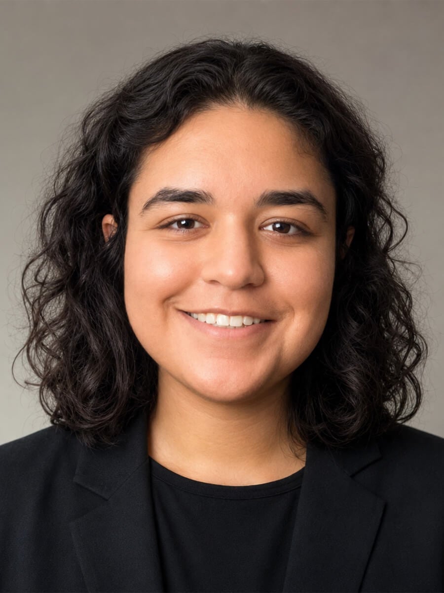 Headshot of a woman who is smiling and wearing a black shirt.