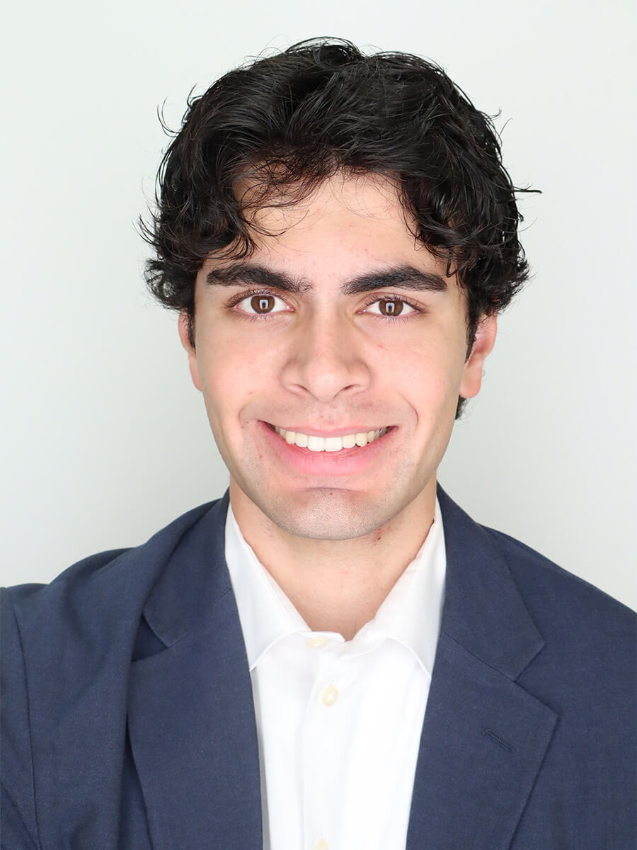 headshot of student wearing white shirt and navy blazer 