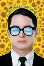 Male person wearing a suit and sunglasses on a background of sunflowers