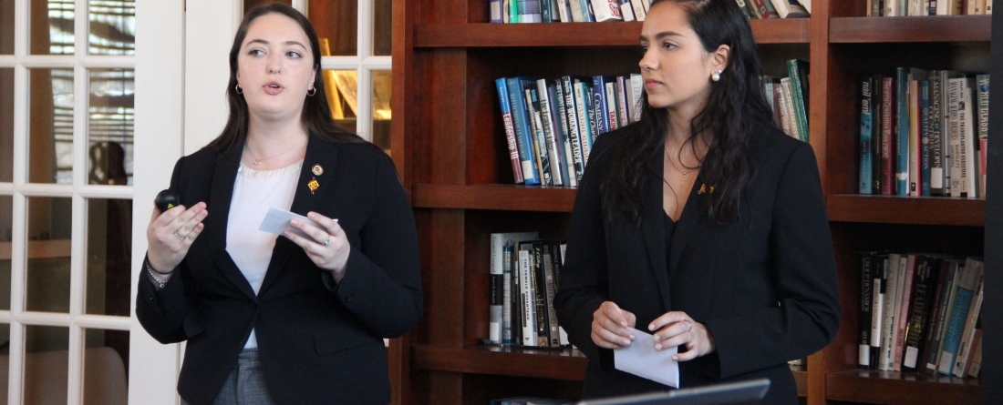 Two students presenting in library