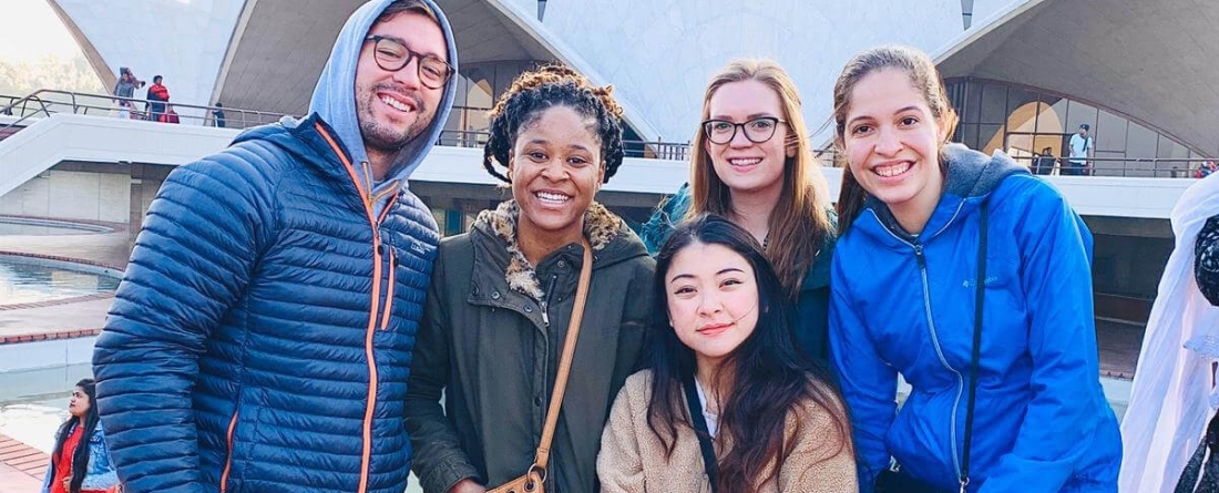 five graduate students smiling