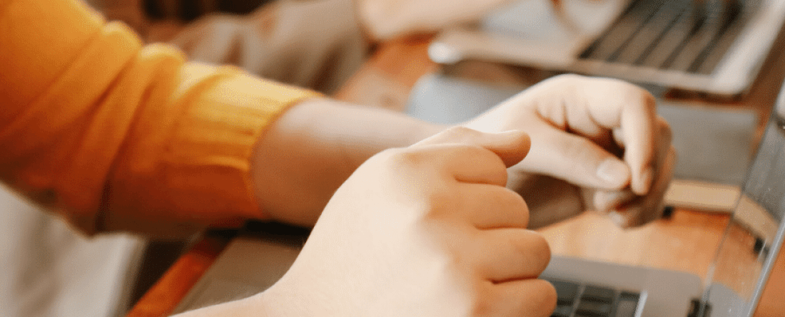 a picture of hands and a laptop key pad
