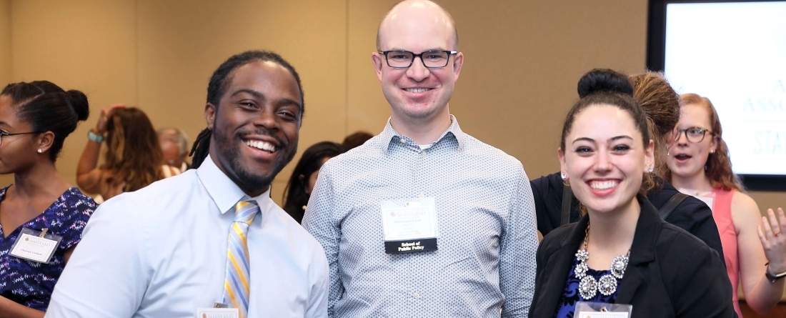 three young professionals smiling at camera