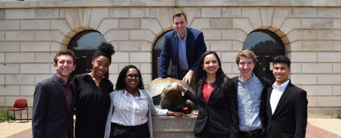 Students in business attire with Testudo