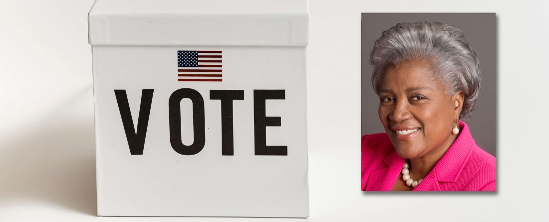 Donna Brazile headshot over image of box that says "VOTE" and voting stickers on table