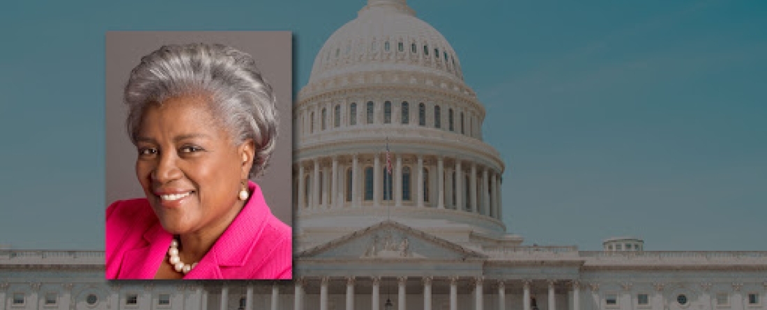 Headshot of Brazile in front of an image of the Capitol 