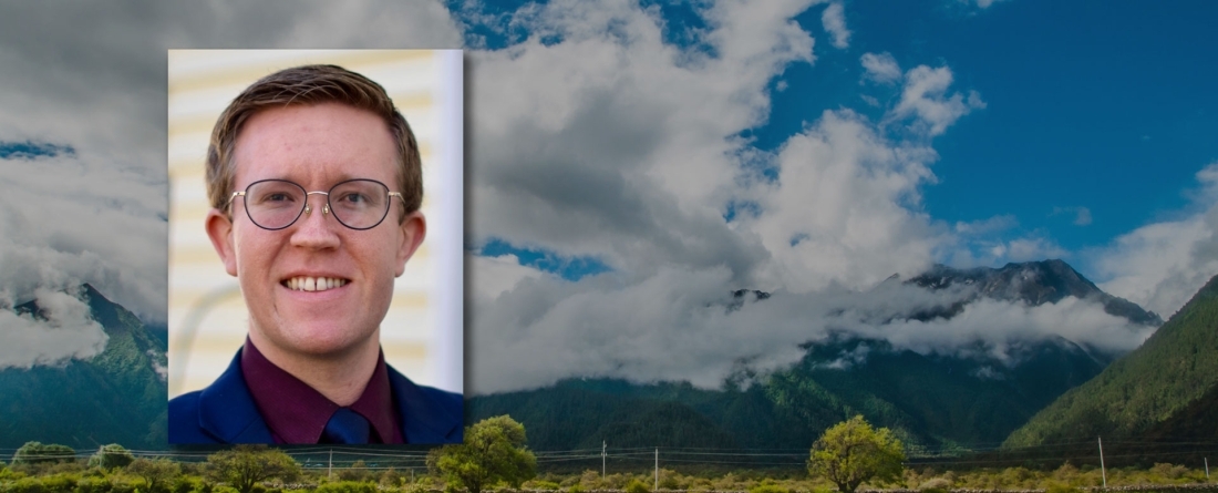 Headshot of Kowan O'Keefe in front of mountain landscape 