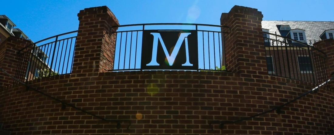 Image of letter M on gate at south campus commons