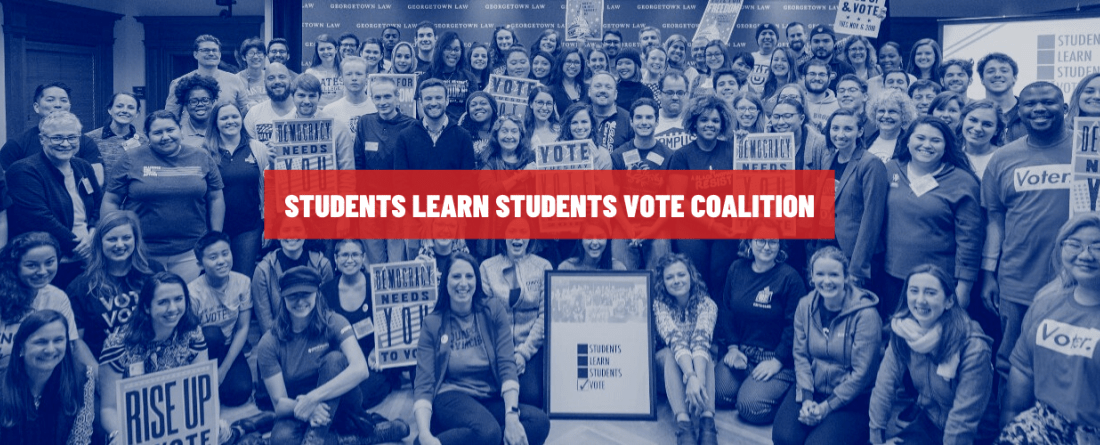 national student vote summit photo with a red banner and people in blue in the background