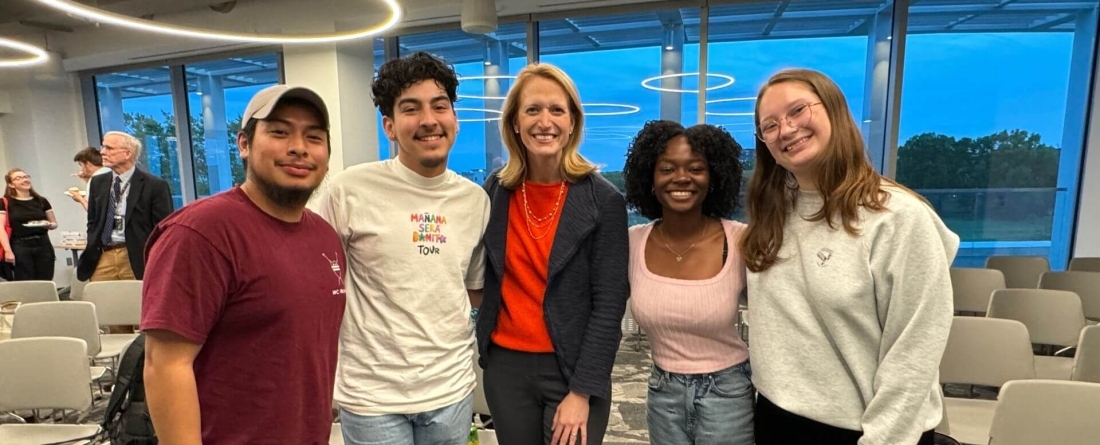 Image of Brooke Lierman (center) with students on both sides