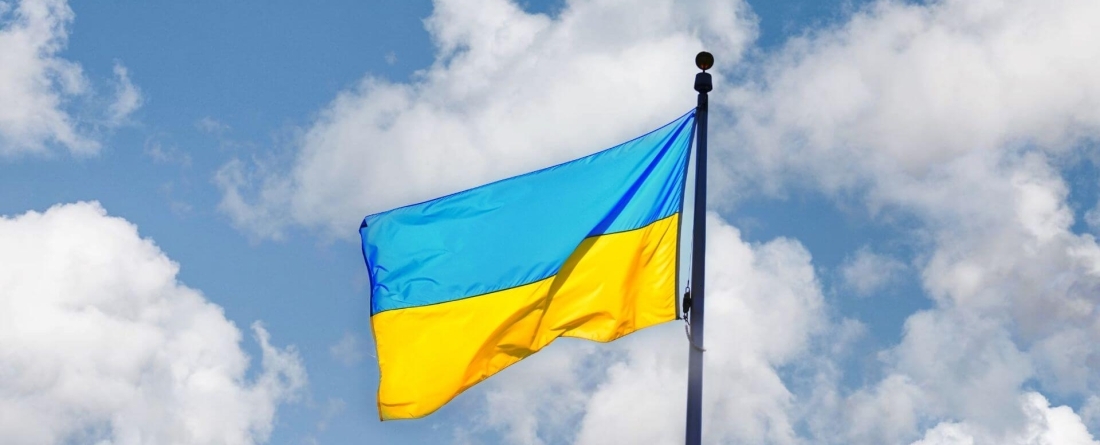 image of Ukraine flag (blue and yellow) against clear blue sky)