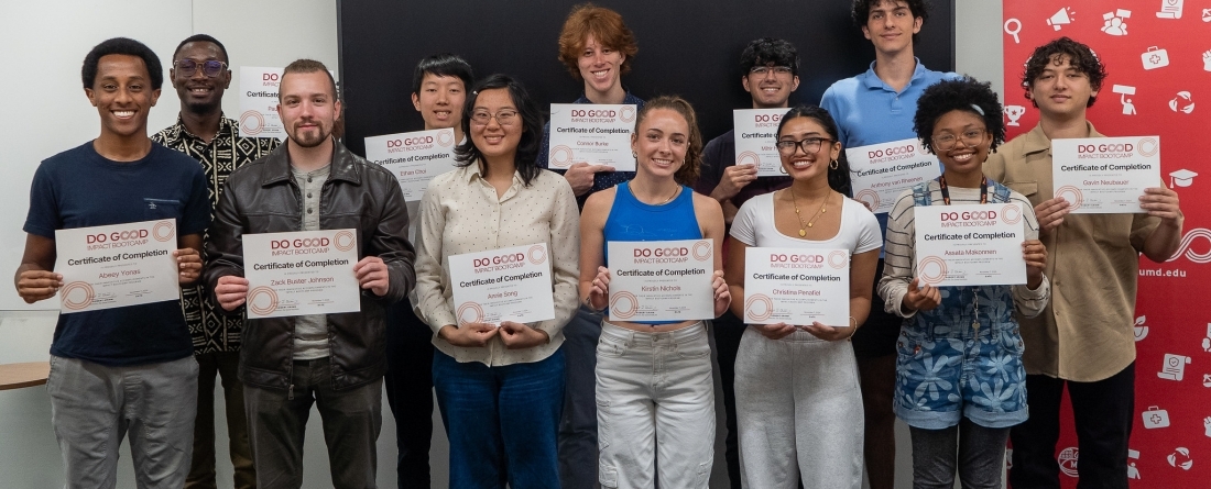 12 students from the Impact Bootcamp program, all standing together smiling and holding up certificates of completion. 