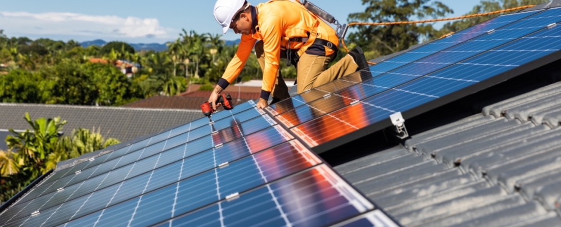 picture of a worker installing a solar panel