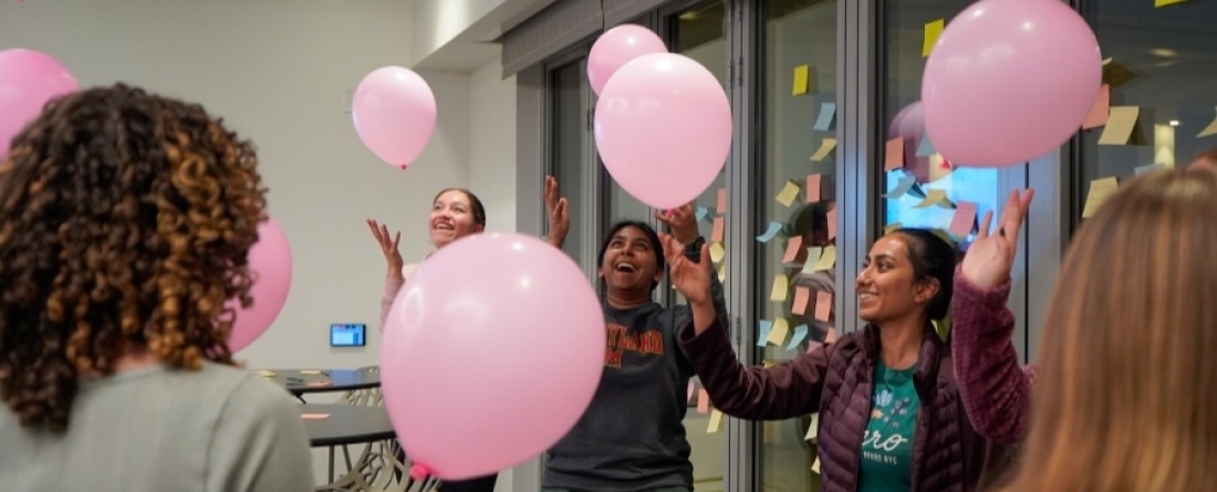 Students playing with pink balloons