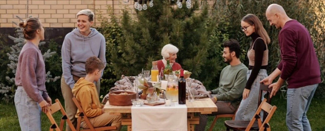 people gathered around a table outdoors