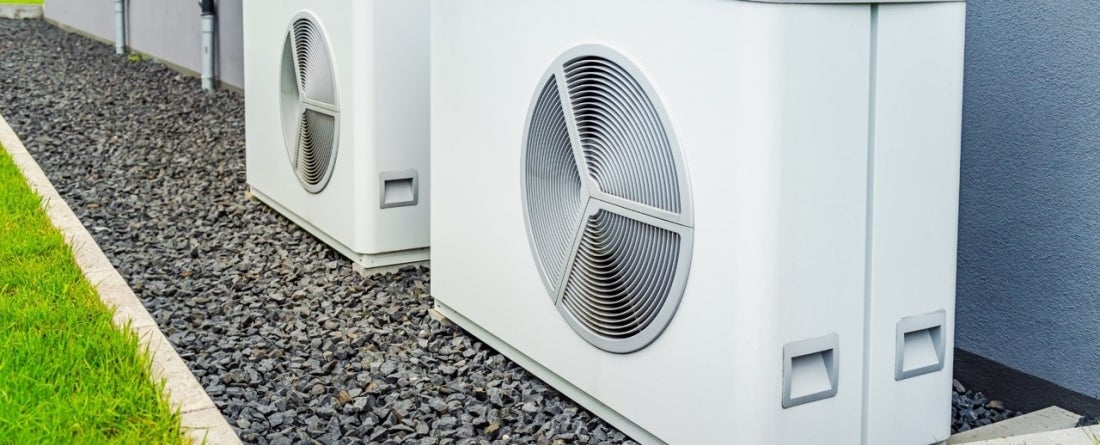 picture of heat pumps in front of a house
