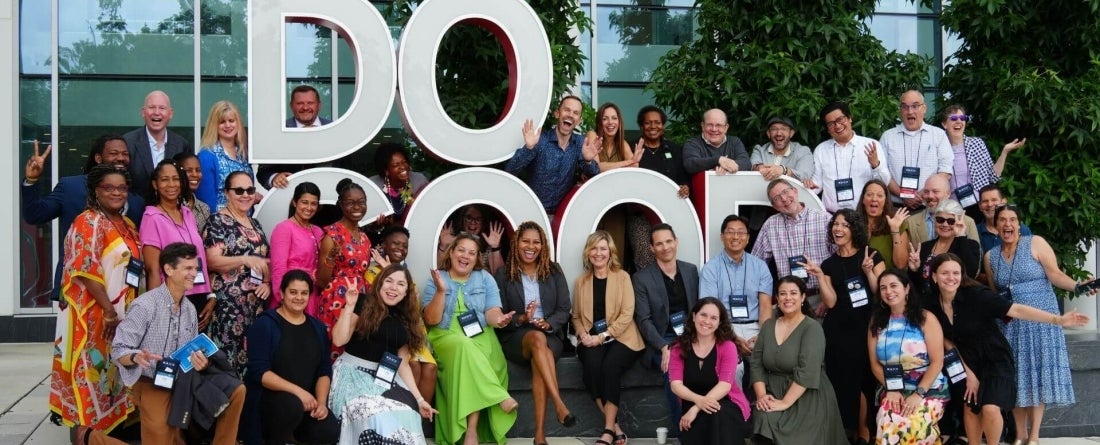 NACC Conference attendees gather in front of the Do Good sign for a group picture outside of Thurgood Marshall Hall.
