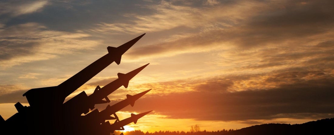 nuclear missiles on a field at sunset