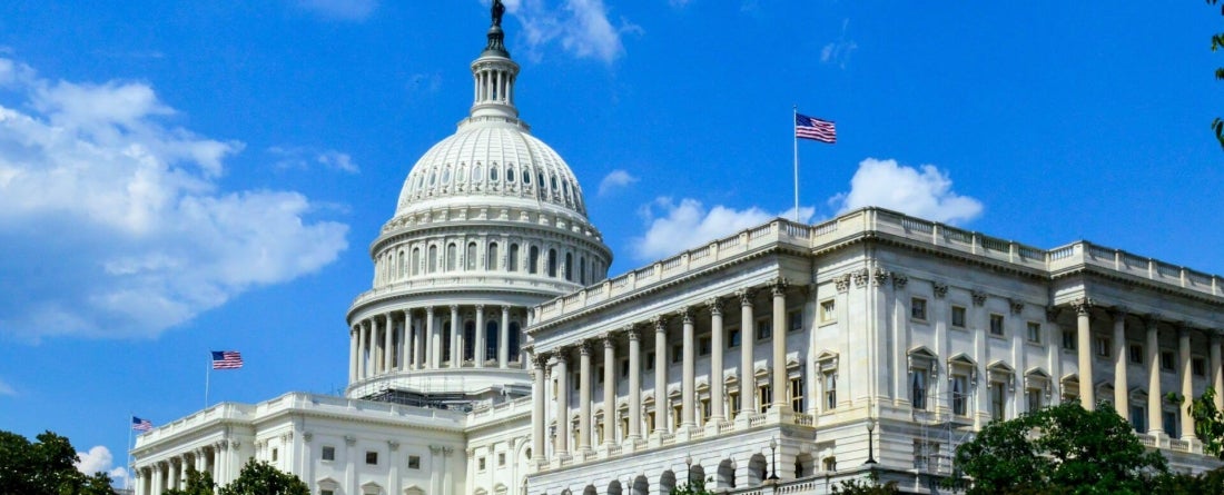 image of U.S. Capitol building against bright blue sky