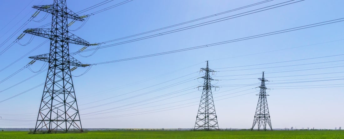 powerlines in an open, grassy, field