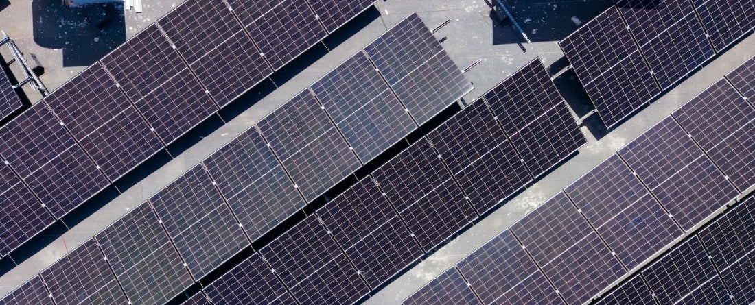 A bird's eye view of solar panels on the roof of a building