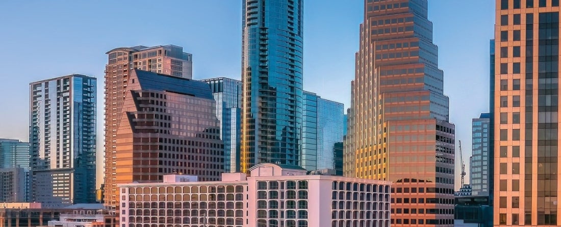 A warm American cityscape with tall buildings in near proximity.